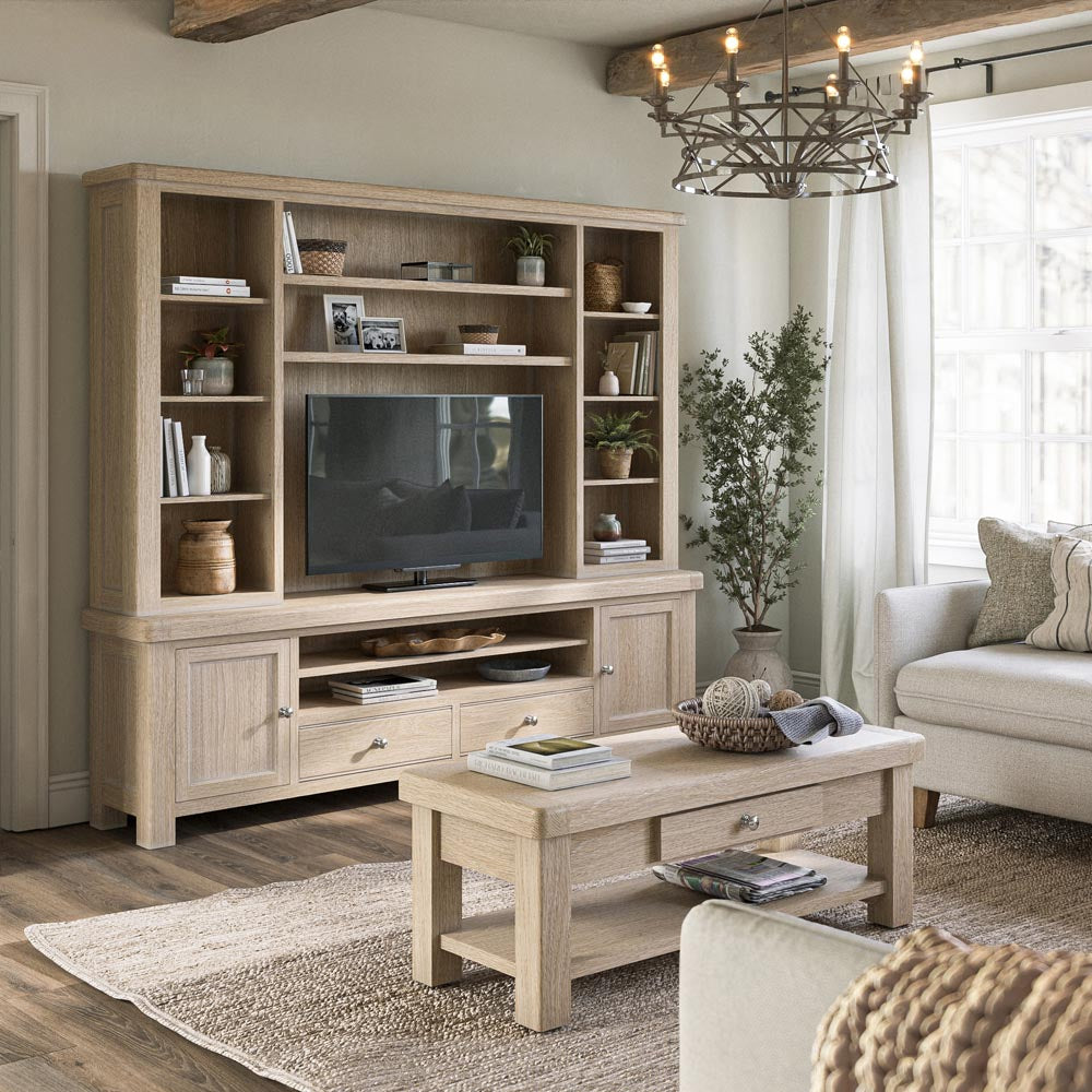 Living room with wooden entertainment center, coffee table, and sofa.