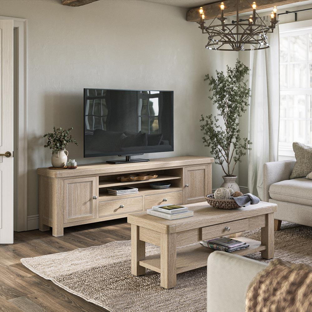 Living room with wooden TV stand, coffee table, and decor elements.