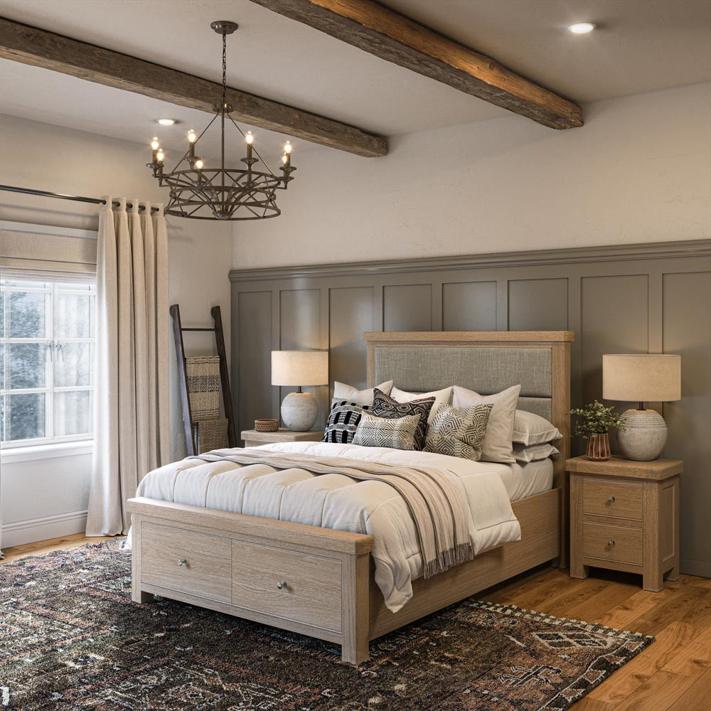 Bedroom with wooden bedframe with drawers, nightstands, and chandelier