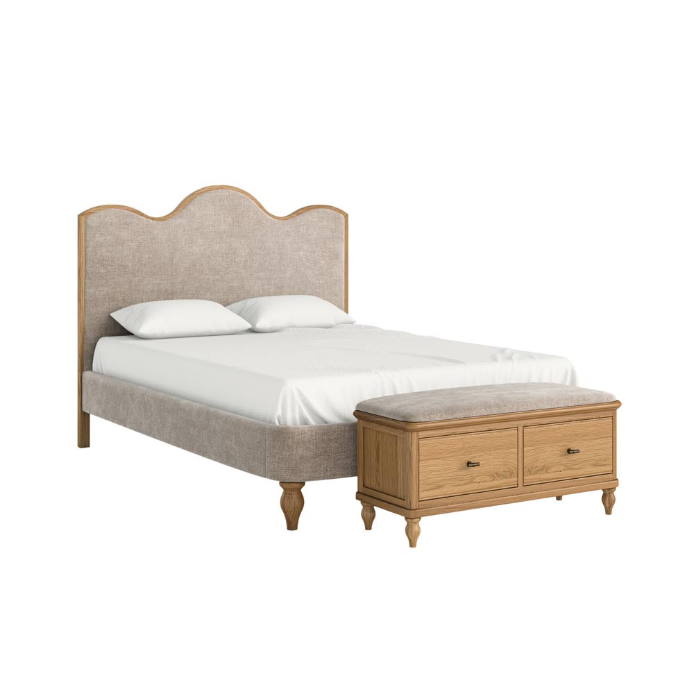 Bed with beige upholstered headboard and wooden bench on a white background