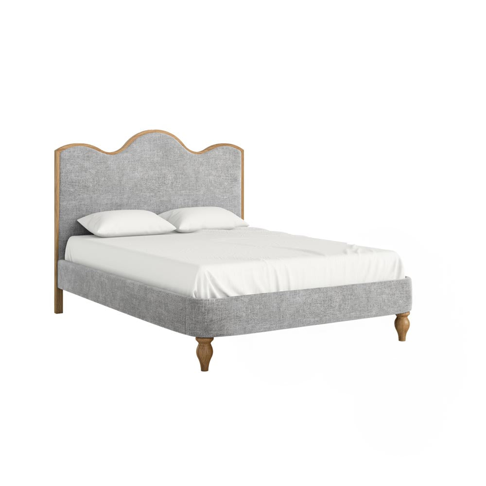 Gray upholstered bed with white bedding on a white background