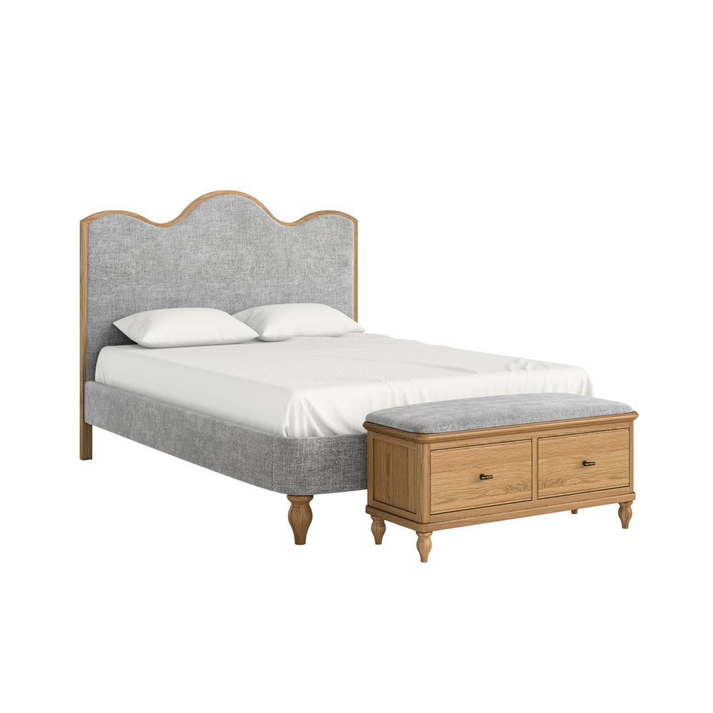 Bed with gray upholstered headboard and wooden bench on a white background