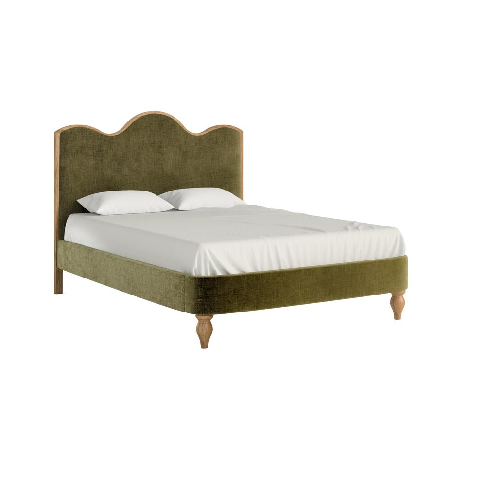 Green upholstered bed with white bedding on a white background