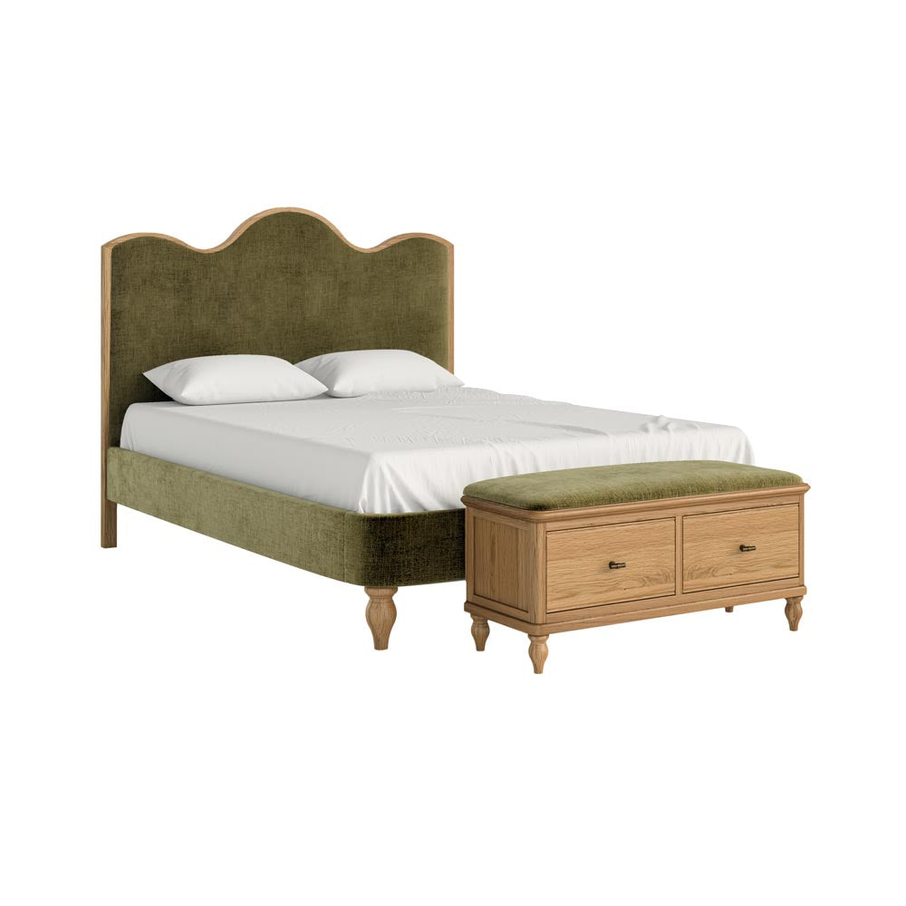 Bed with green upholstered headboard and wooden bench on a white background