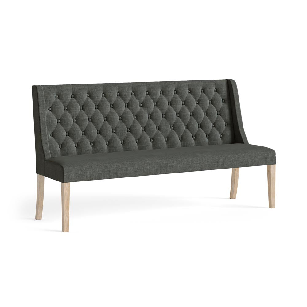 Charcoal tufted bench with wooden legs on a white background