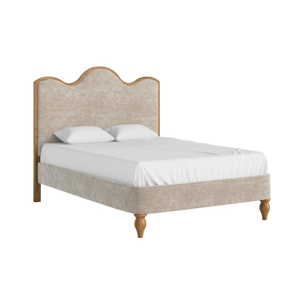 Bed with oatmeal coloured upholstered headboard and white bedding on a white