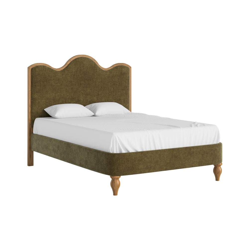 Bed with green upholstered headboard and white bedding on a white background
