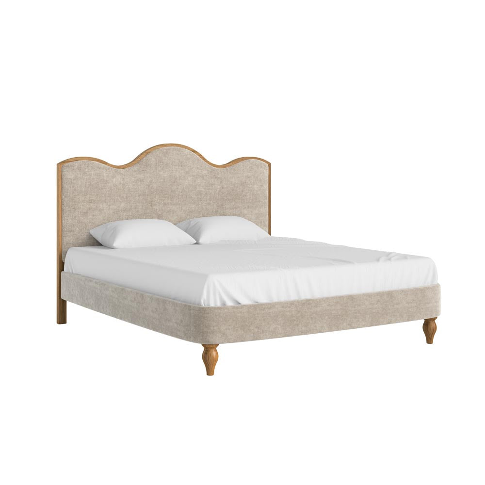 Beige upholstered bed with white bedding on a white background