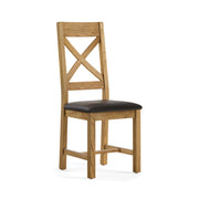 oak chair with a cross back design and black leather seat.