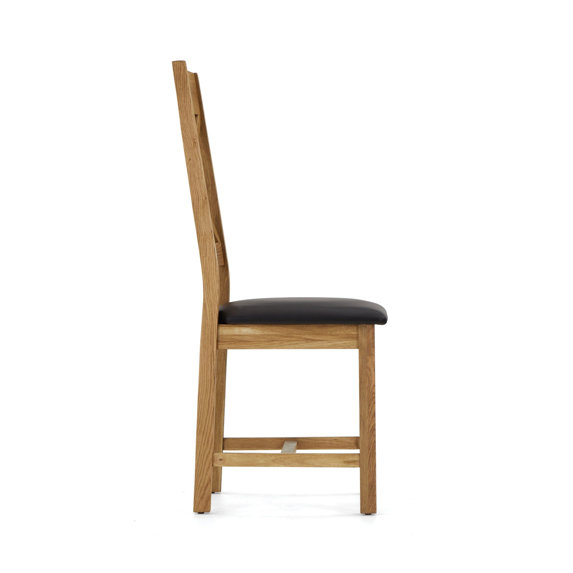 oak chair with a cross back design and black leather seat. side view