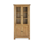 tall oak display cabinet with double glass doors, 3 upper shelves and concealed storage underneath behind two oak doors.