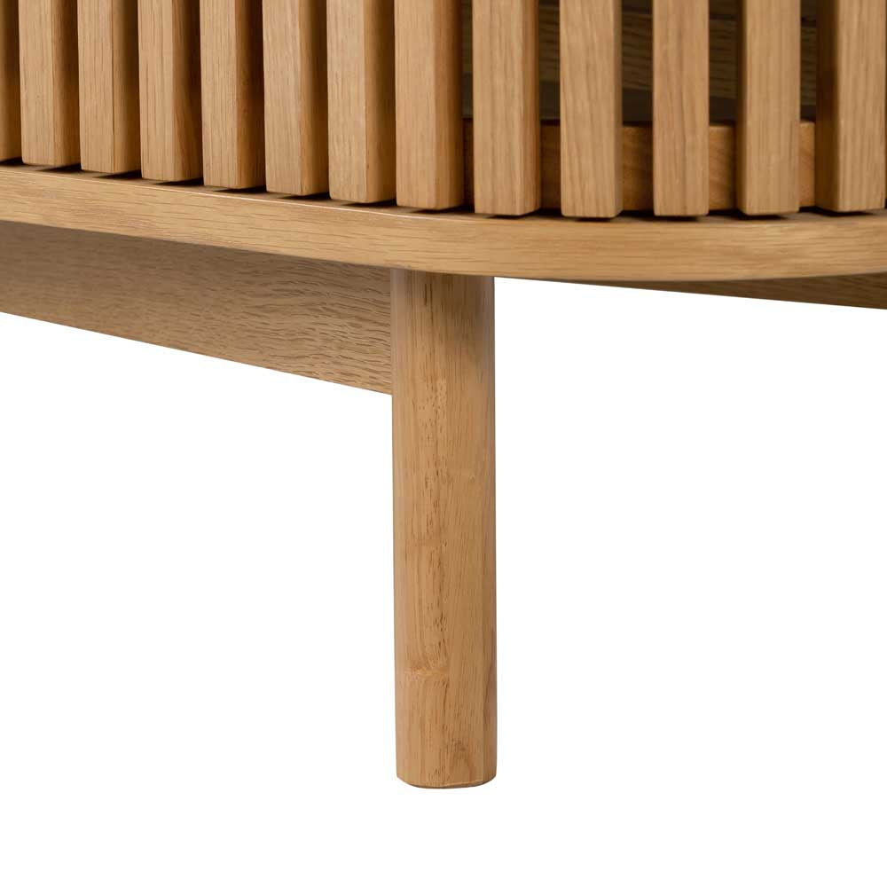 Close-up of TV unit leg with slatted cupboard door just visible on a white background