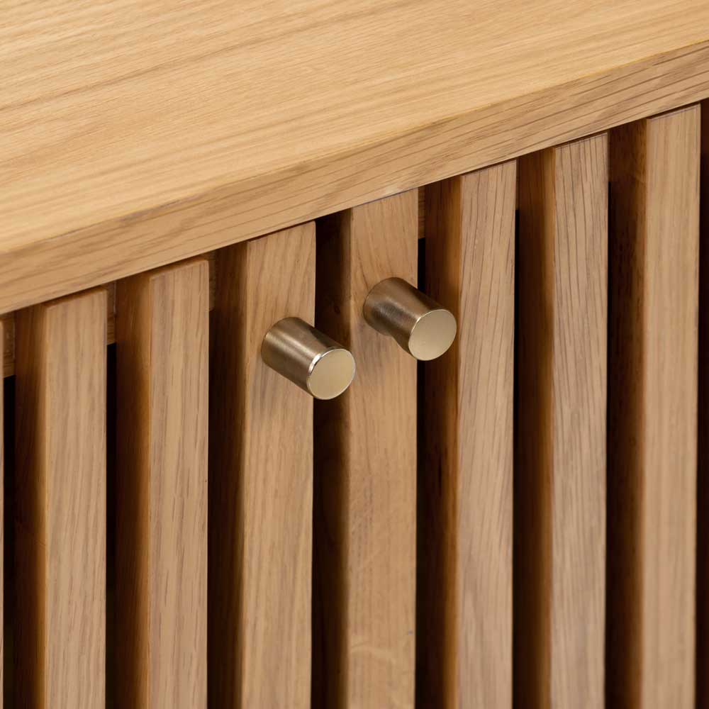 Wooden freestanding cupboard with slatted design, closeup of gold coloured metallic handles
