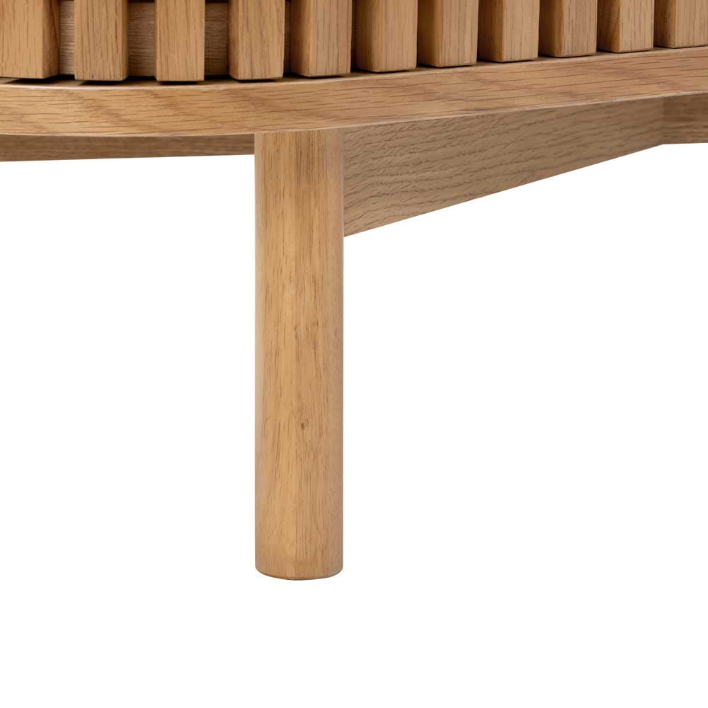 Close up of oak sideboard leg, with slatted door just visible above.