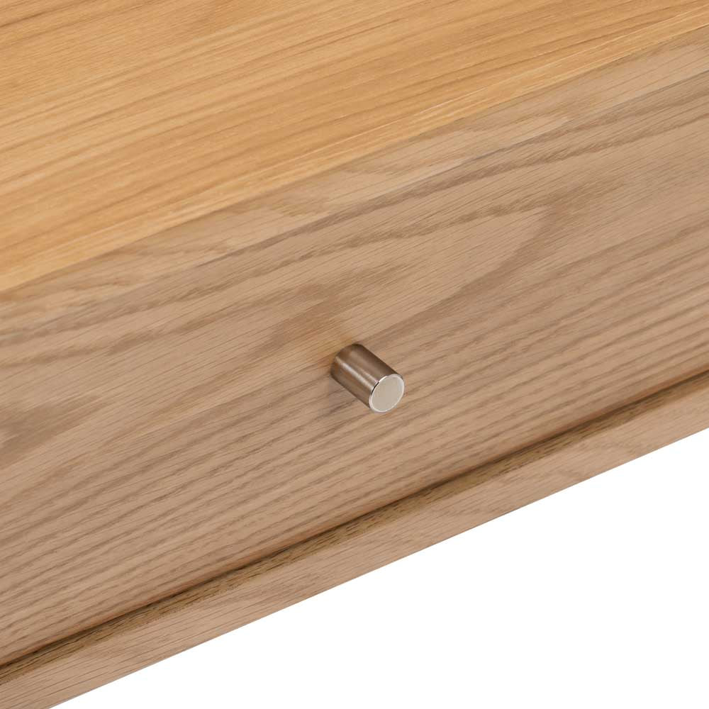 Wooden drawer with a metallic gold effect handle on a white background
