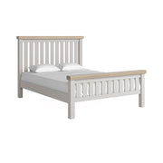 Grey slatted king bedframe with white matress and pillow and oak tops on headboard and footboard.