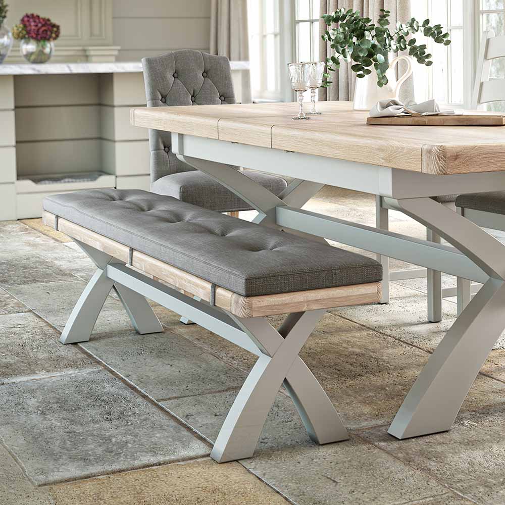 Long oak dining bench, painted grey with a medium grey coloured cushion. The bench is shown next to a matching table for reference / inspiration