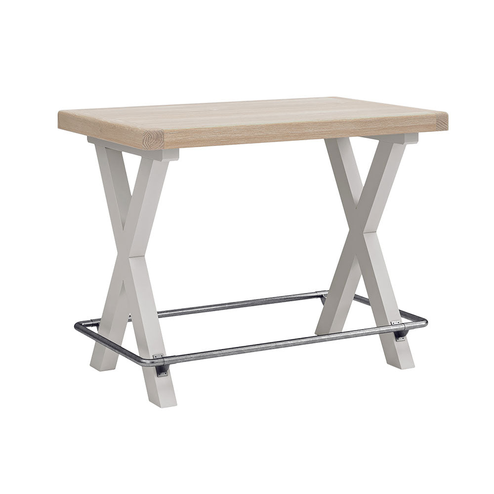 Grey painted oak bar table with X shaped leg design and metal wrap around footrest.