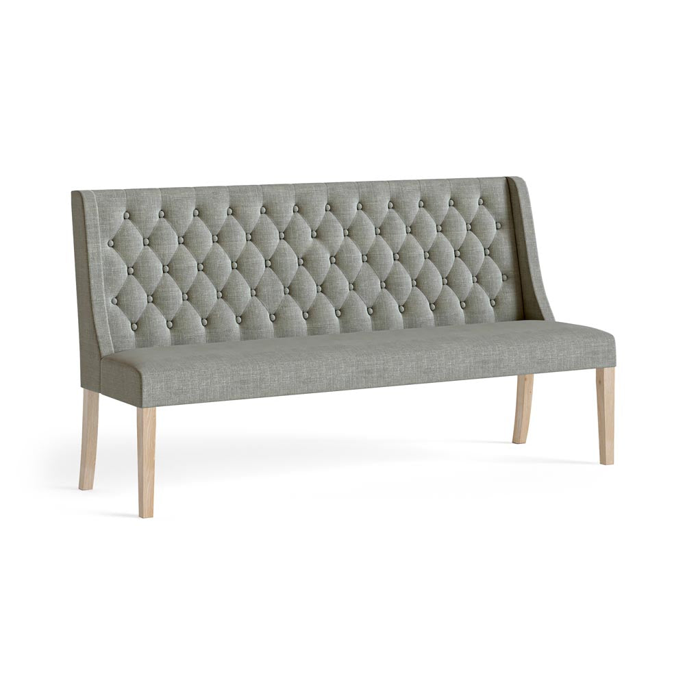 Gray tufted bench with wooden legs on a white background