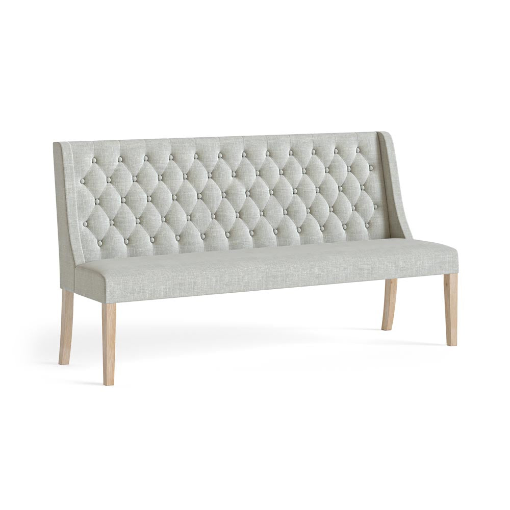 Beige tufted bench with wooden legs on a white background