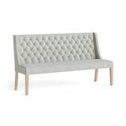 Beige tufted bench with wooden legs on a white background