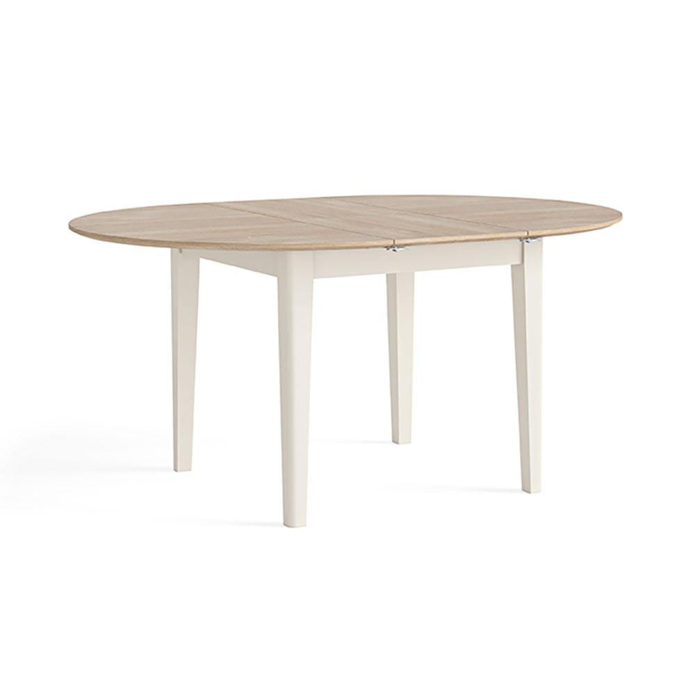 Round oak dining table with 4 legs, fully extended to form an oval dining table.