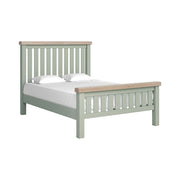 Sage slatted double bed with white matress and pillow and oak tops on headboard and footboard