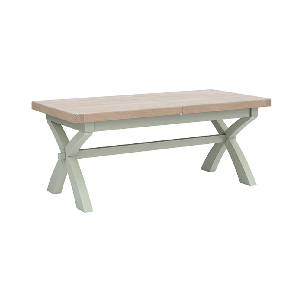 Sage painted oak extending table with X shaped leg design.