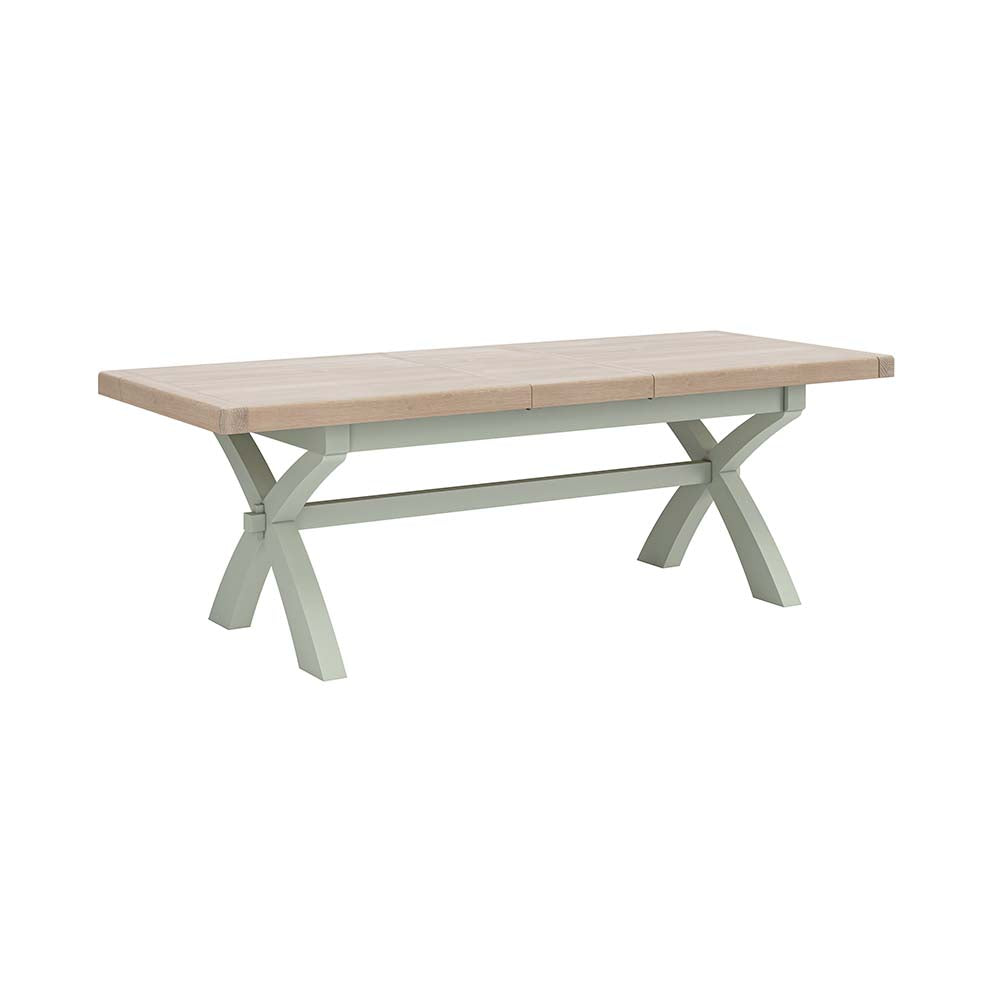 Sage painted oak extending table with X shaped leg design.