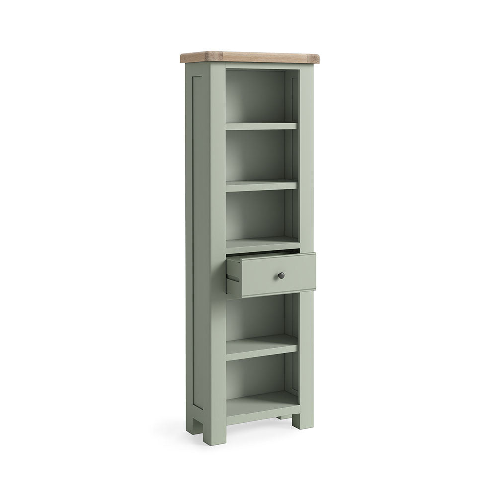 Sage green painted oak slim bookcase with 5 open shelves and one small drawer under the 3rd shelf.