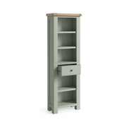 Sage green painted oak slim bookcase with 5 open shelves and one small drawer under the 3rd shelf.