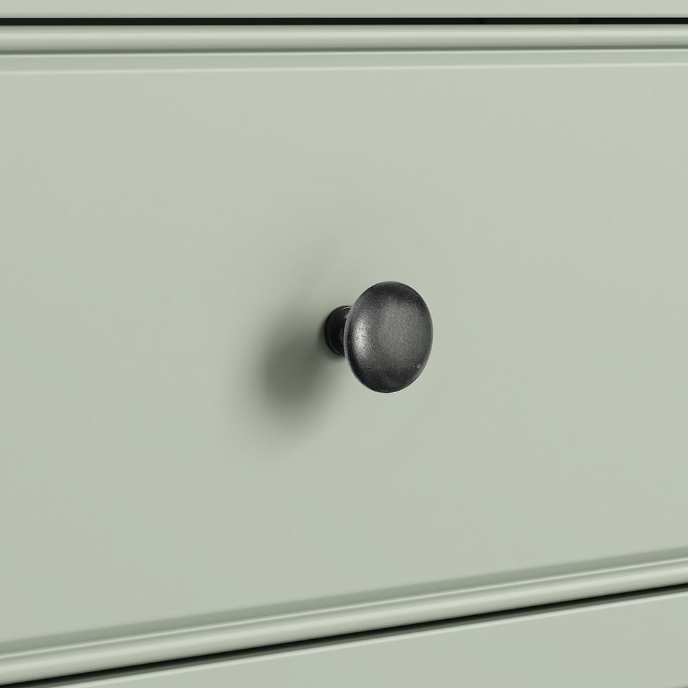 close up of sage green drawer with antique knob.