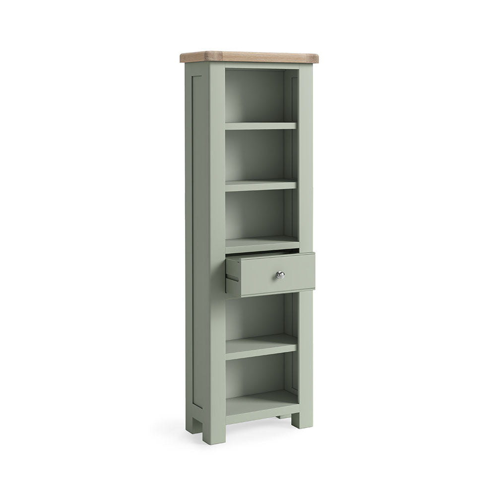 Sage green painted oak slim bookcase with 5 open shelves and one small drawer under the 3rd shelf.
