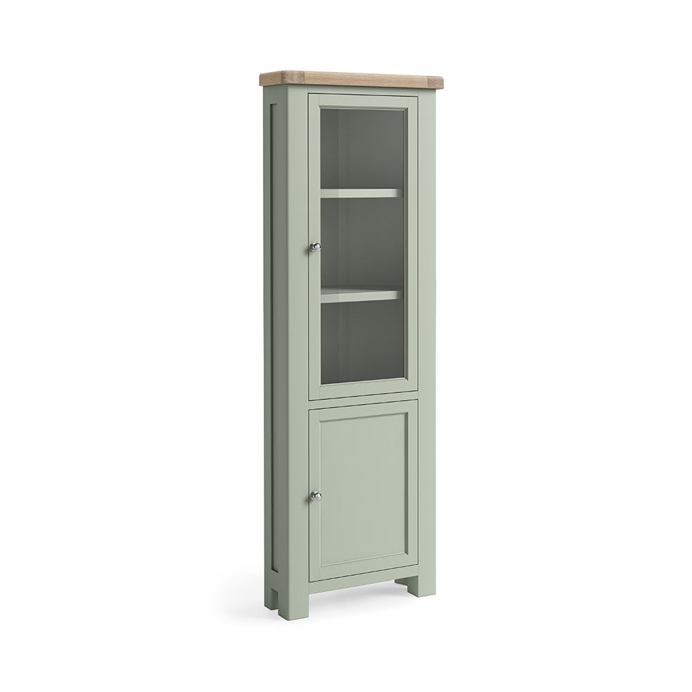Oak display cabinet, with two doors, the top door has a glass panel, and 3 shelves are visible inside. the bottom door is solid oak and encloses a further 2 shelves. the whole unit is painted sage green, except for the unpainted oak top