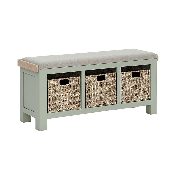 Sage painted oak hallway storage bench with storage baskets under the seat. Beige cushion on the bench.