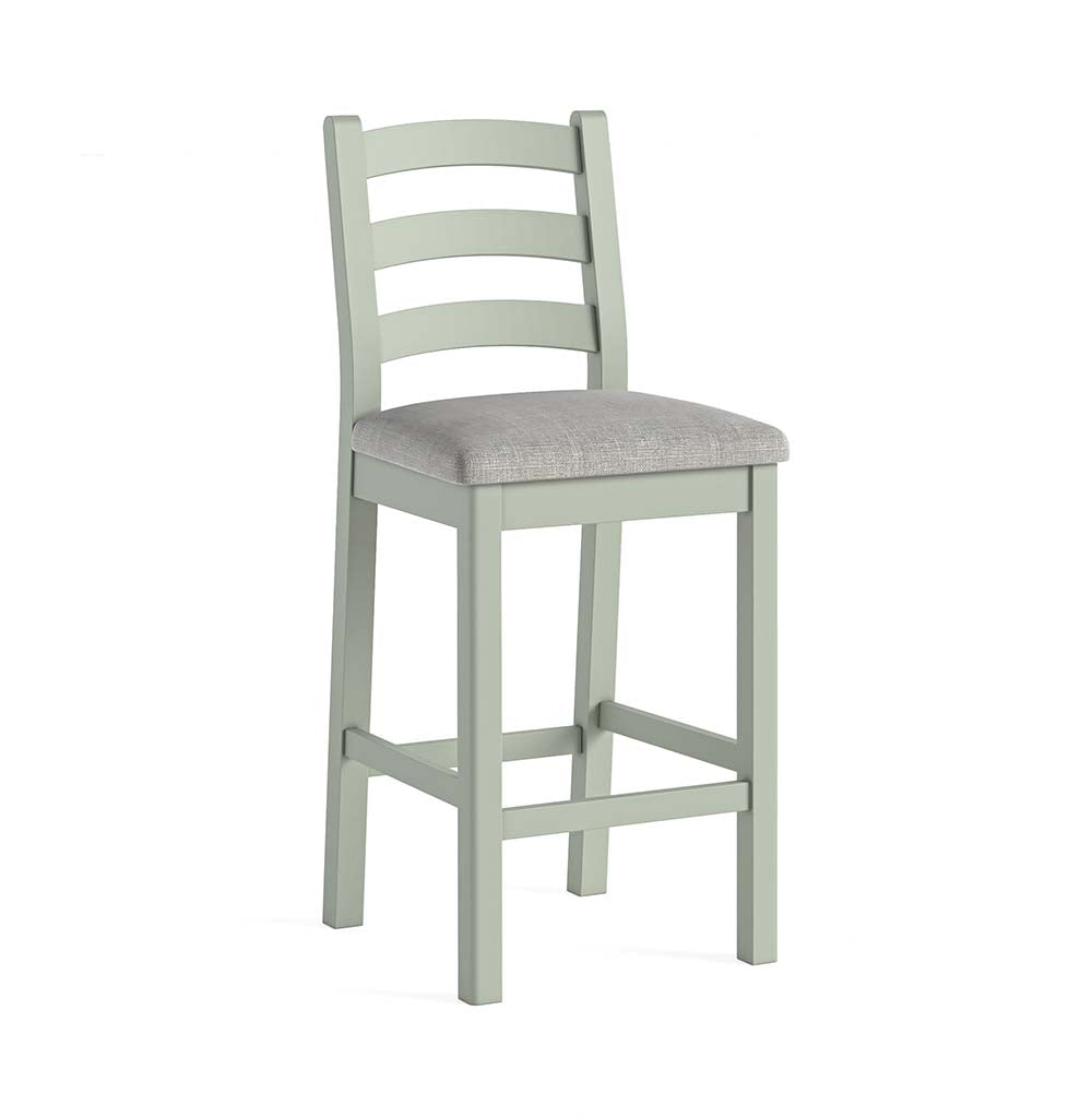 Sage painted oak bar stool with grey cushion and footrest bars between all four legs.