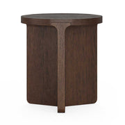 A dark brown wooden side table with a cross shaped solid base and a round top, shown against a plain white background.