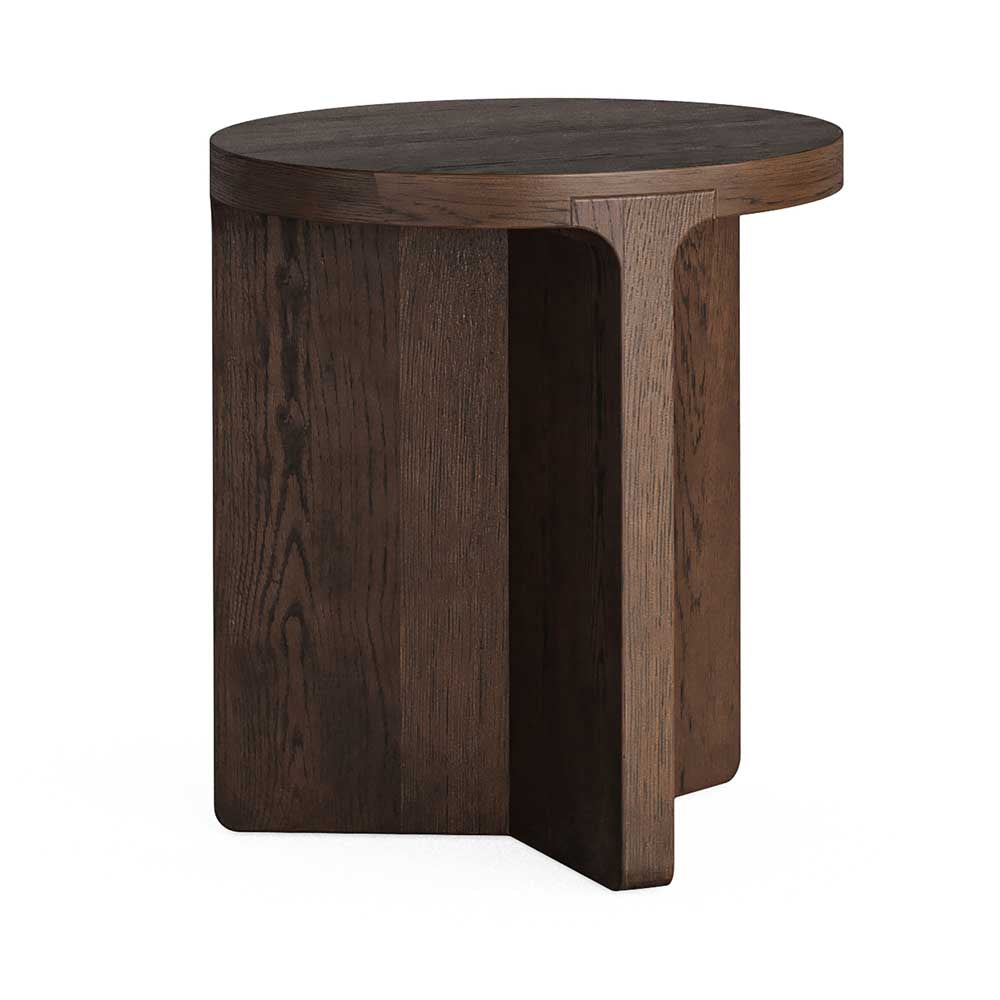 A dark brown wooden side table with a round top and a sculptural, block-like base, shown on a plain white background.