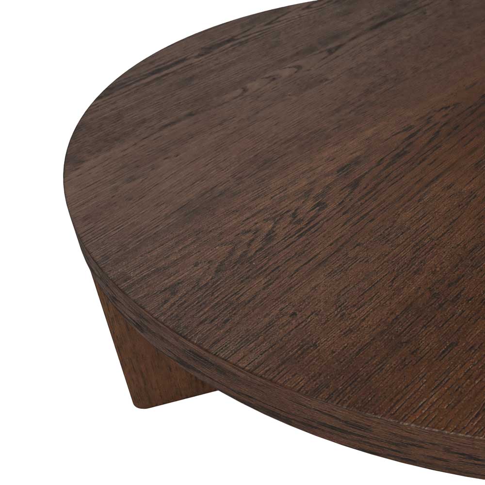 Close-up of a dark brown wooden table showing the curved tabletop edge and part of the wooden leg against a white background.