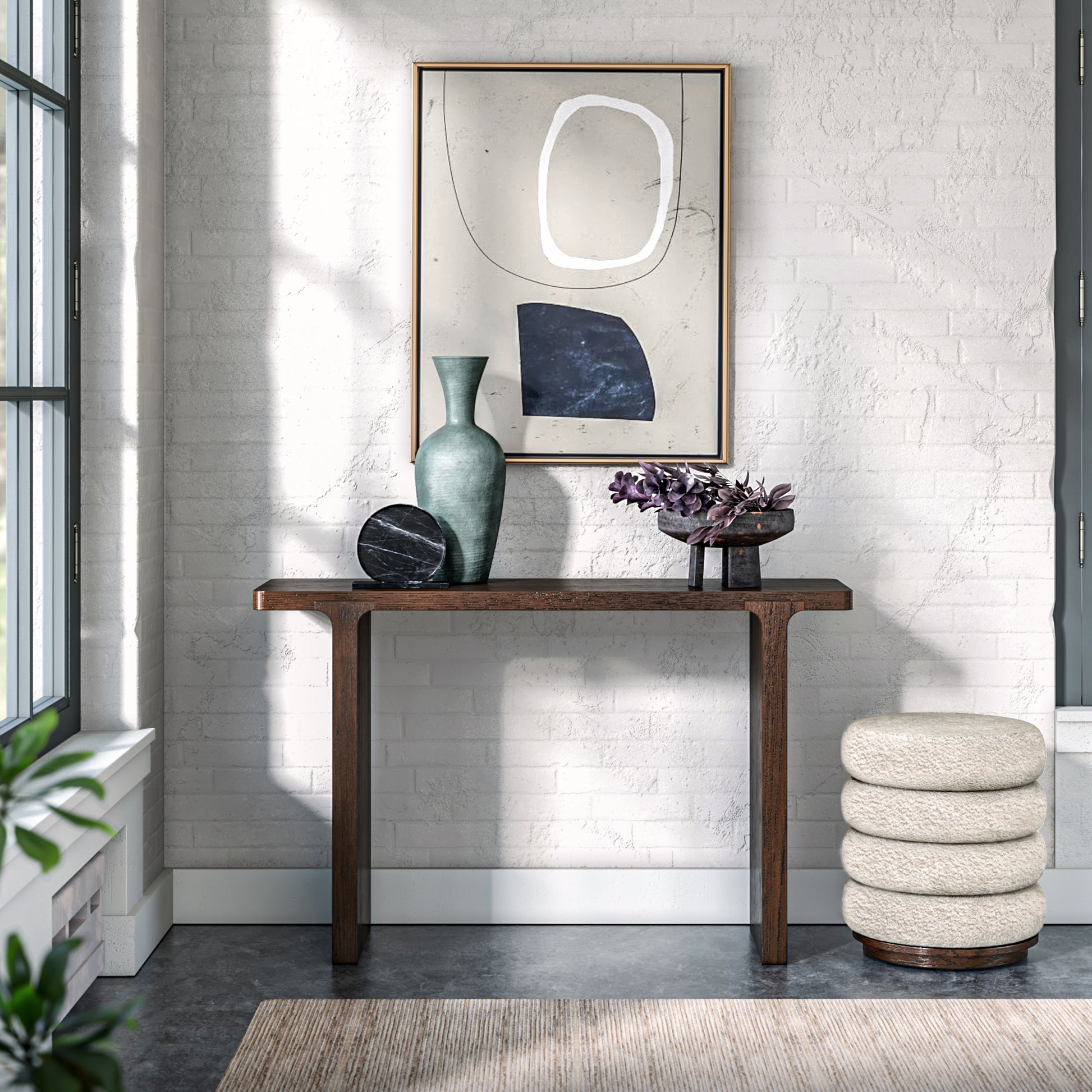 Modern interior with a console table, mirror, and decorative items against a white brick wall.