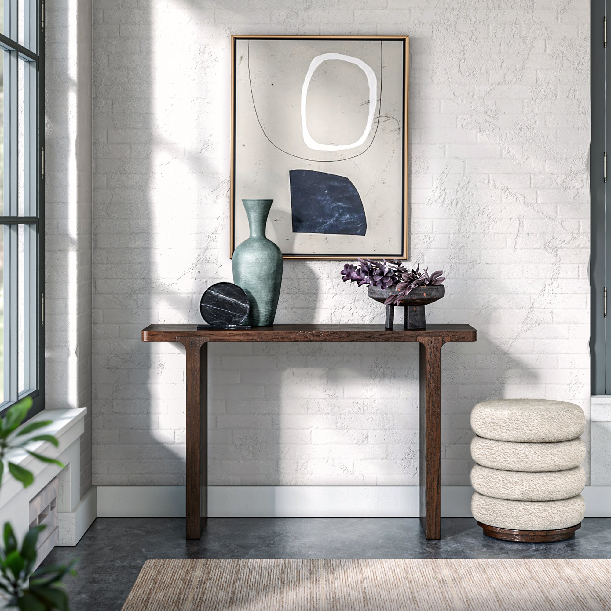 Modern interior with a console table, mirror, and decorative items against a white brick wall.