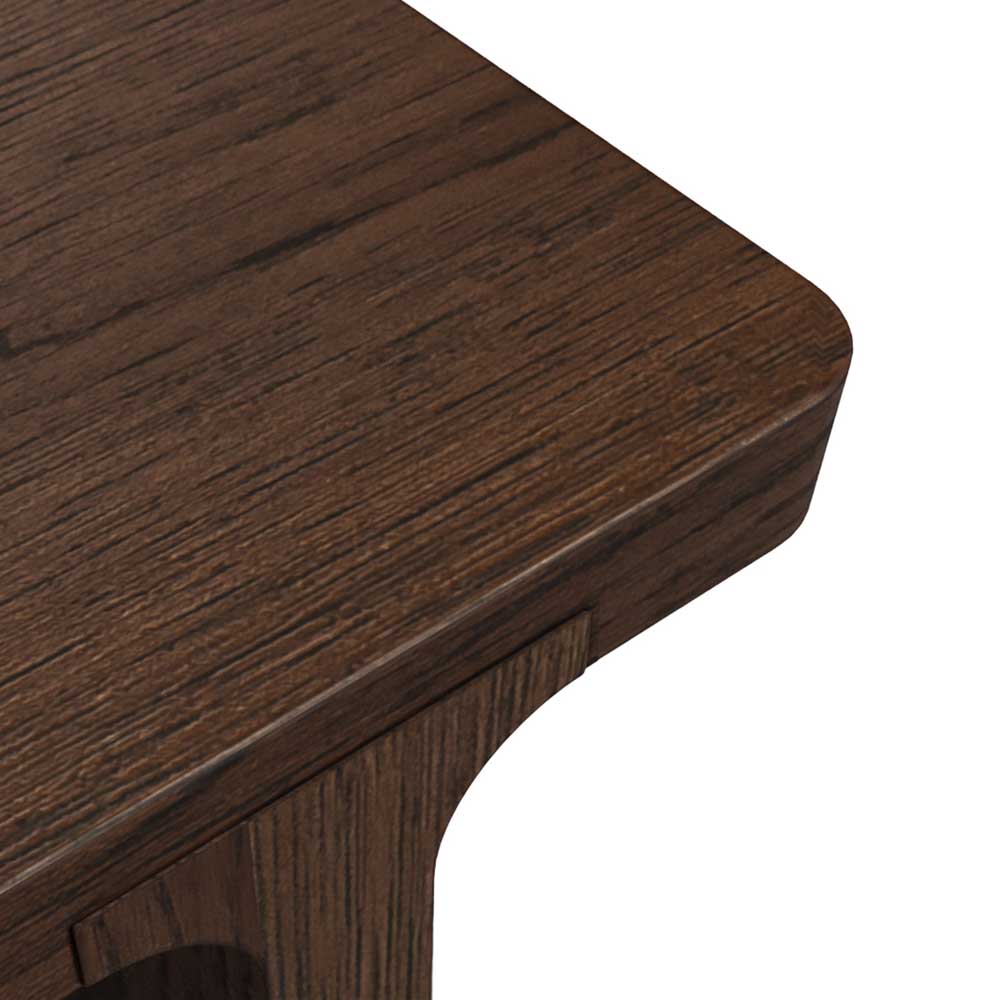 Close-up of a dark brown wooden table corner showing the wood grain texture and rounded edge against a white background.