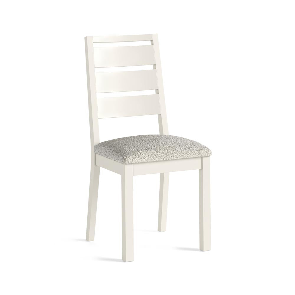 White chair with a white boucle fabric seat on a white background