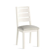 White chair with a white boucle fabric seat on a white background
