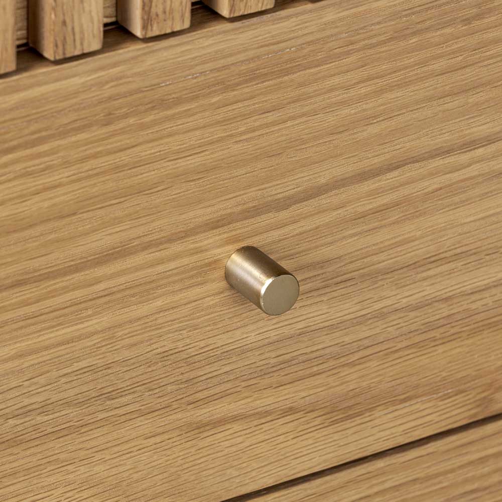 Close-up of a wooden drawer with a fold effect handle