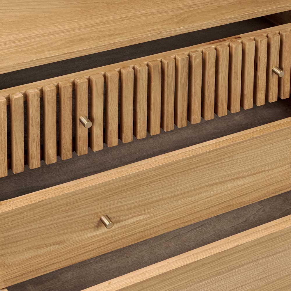Wooden drawers with horizontal slats and metal knobs on a wooden surface.