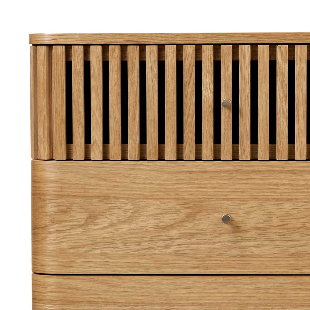 Wooden chest of drawers with slatted top drawer and enclosed drawer on a white background