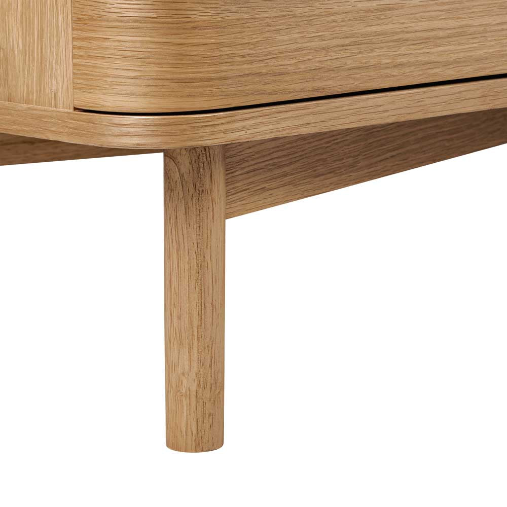 Close-up of a wooden chest of drawer leg on a piece of furniture with a white background