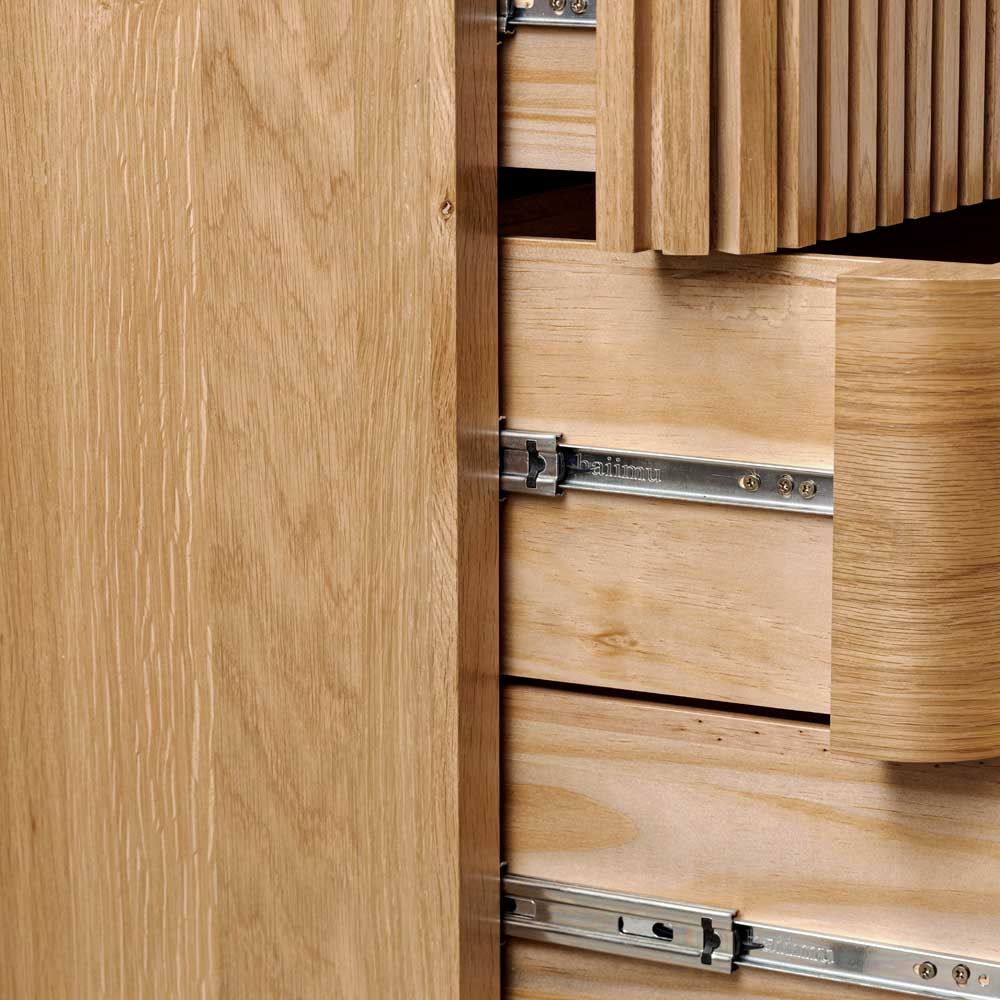 Wooden chest of drawers with open drawer and visible hinges