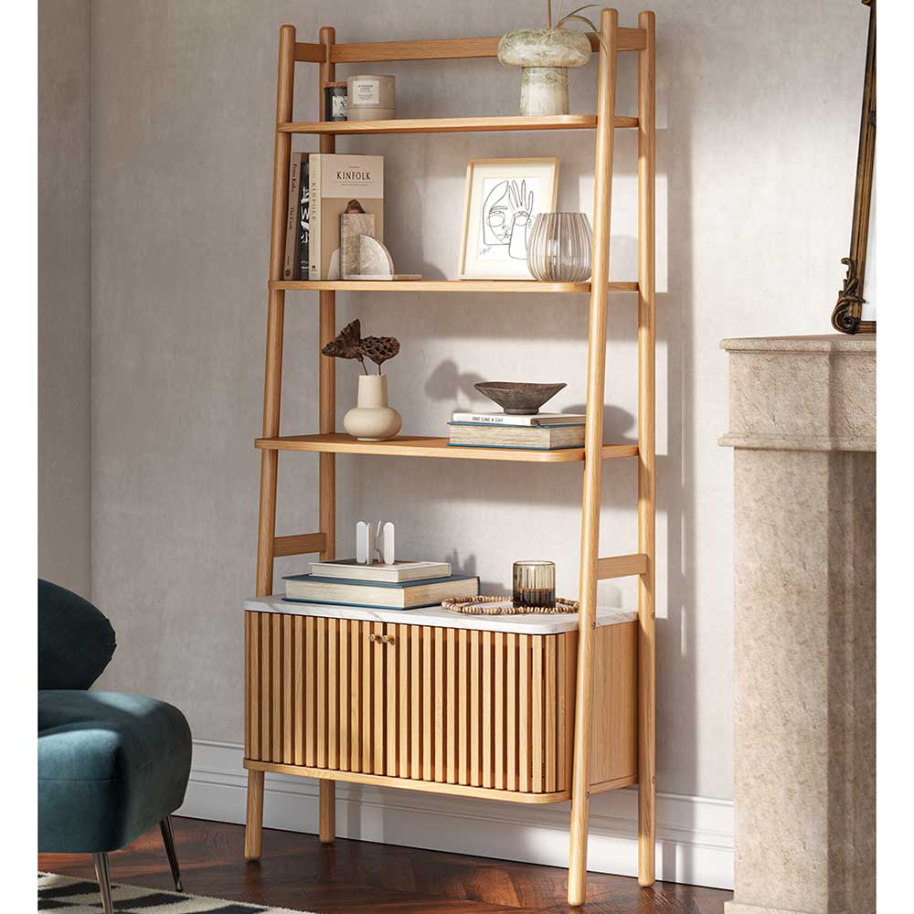 Wooden ladder shelf with decorative items against a neutral wall.